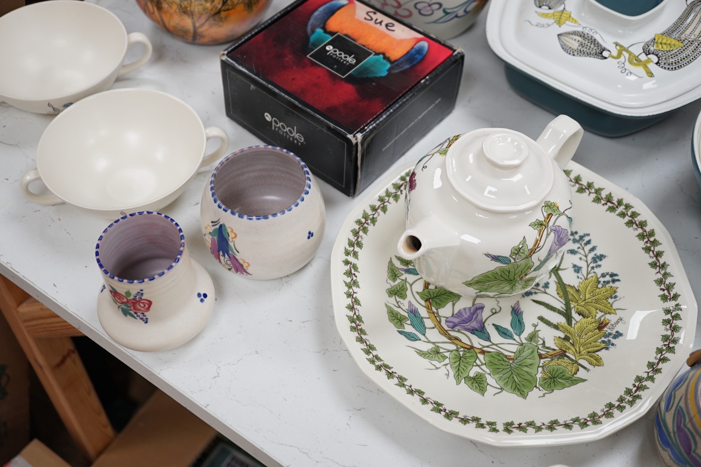 A collection of Poole pottery teapots, plates etc.